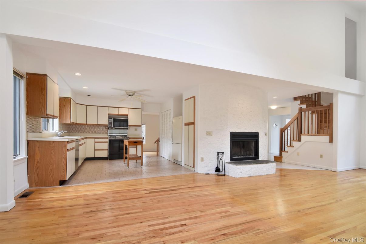 Fireplace, Interior, Kitchen, Recessed Lighting, Stainless Steel Appliances, Wood Texture Flooring