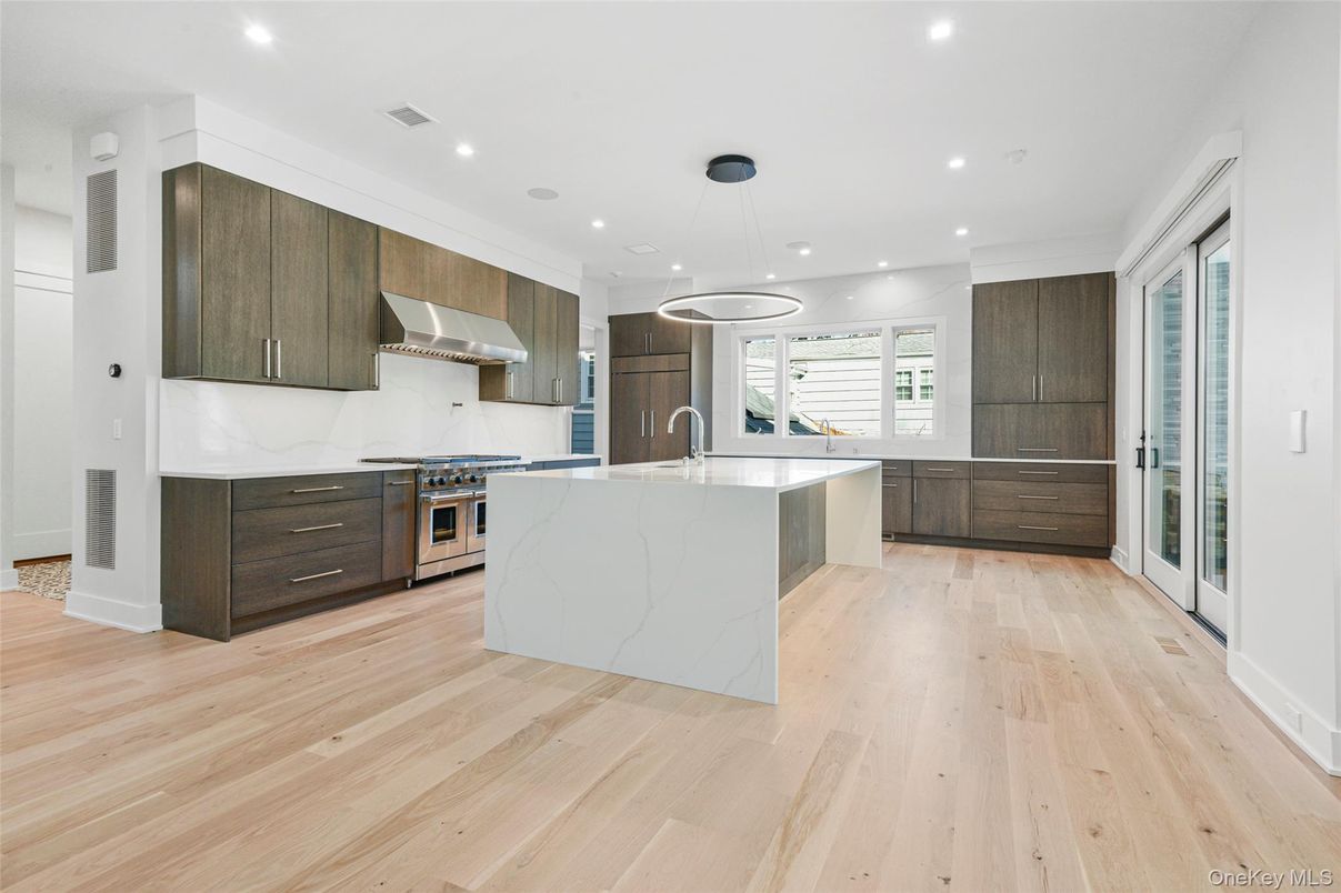 Interior, Kitchen, Marble Walls, Pendant Lights, Recessed Lighting, Stainless Steel Appliances, Wood Texture Flooring
