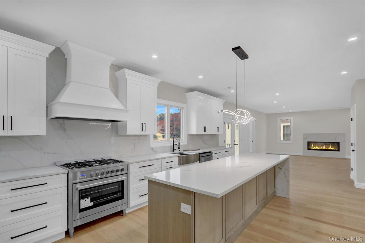 Fireplace, Interior, Kitchen, Marble Walls, Pendant Lights, Recessed Lighting, Stainless Steel Appliances, Wood Texture Flooring