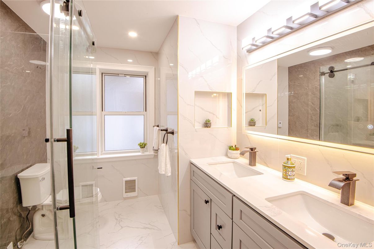 Bathroom, Dual Sink Vanities, Glass Shower, Interior, Marble, Marble Walls, Recessed Lighting