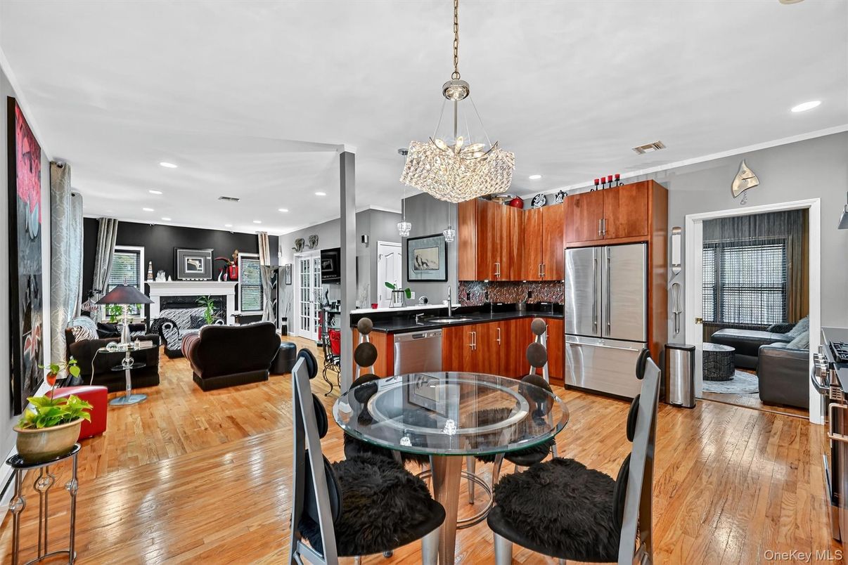 Chandelier, Dining room, Fireplace, Interior, Kitchen, Living room, Pendant Lights, Recessed Lighting, Stainless Steel Appliances, Wood Texture Flooring