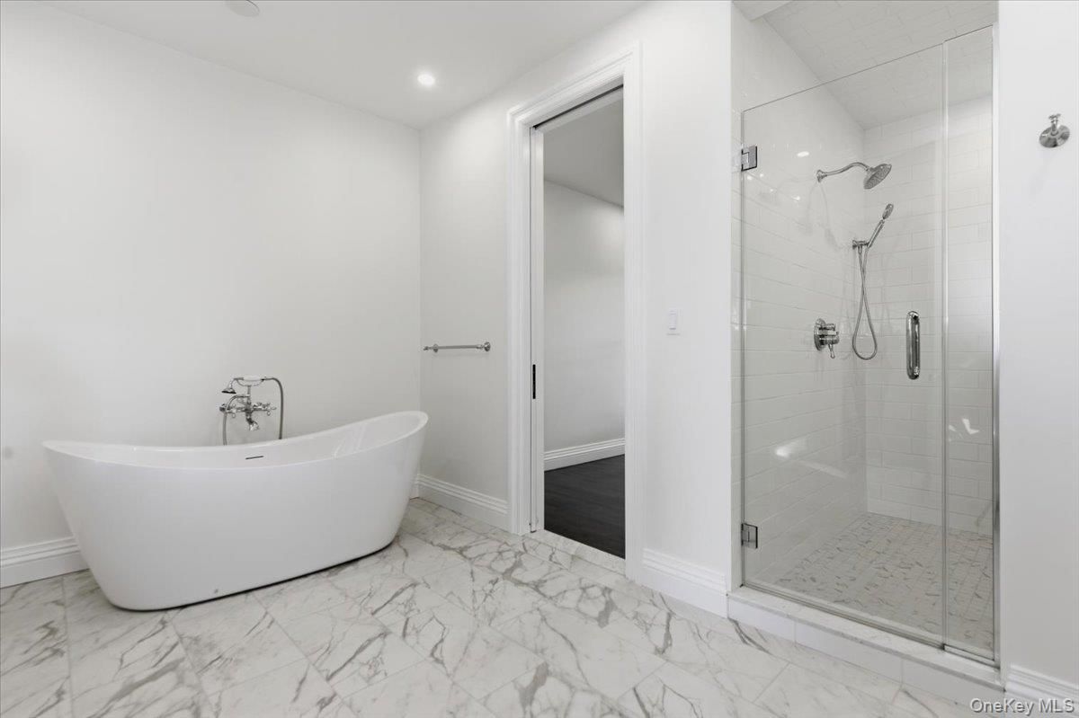 Bathroom, Free Standing Baths, Glass Shower, Interior, Marble, Marble Walls, Recessed Lighting