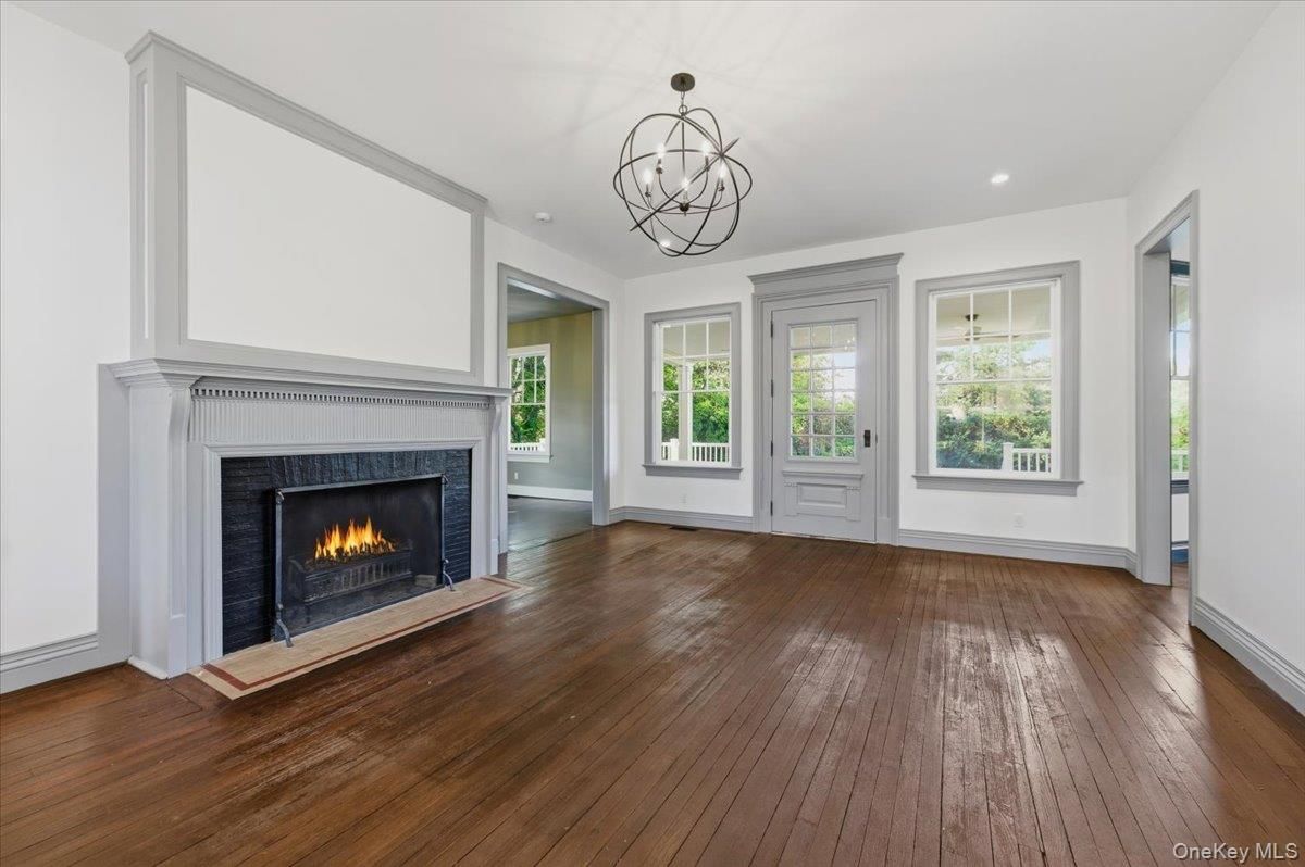 Chandelier, Empty room, Fireplace, Interior, Recessed Lighting, Wood Texture Flooring
