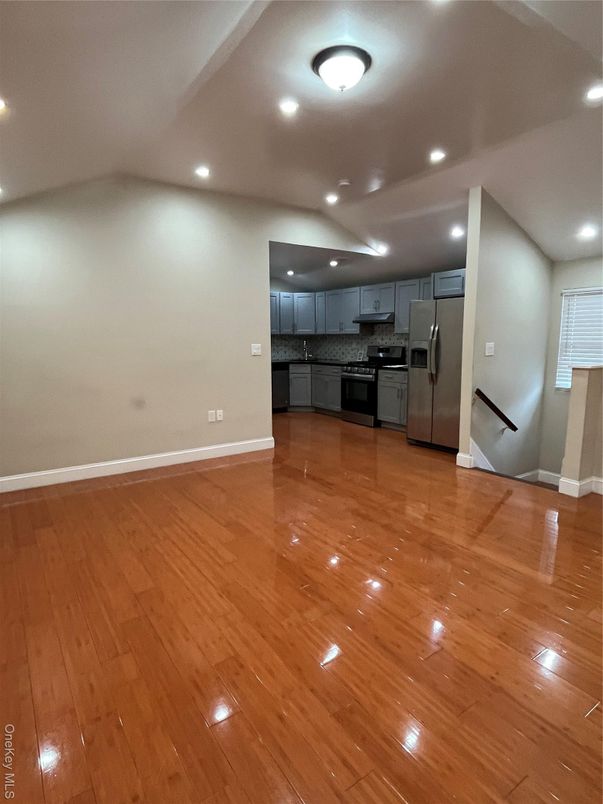 Empty room, Interior, Kitchen, Recessed Lighting, Stainless Steel Appliances, Wood Texture Flooring