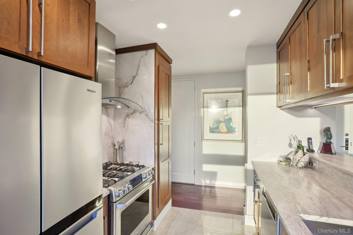 Interior, Kitchen, Marble Walls, Recessed Lighting, Stainless Steel Appliances, Wood Texture Flooring