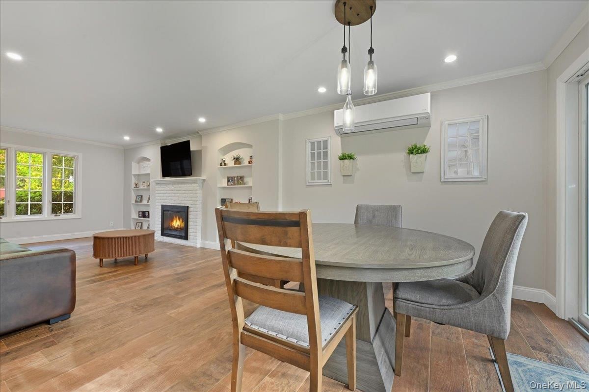 Dining room, Fireplace, Interior, Living room, Pendant Lights, Recessed Lighting, Wood Texture Flooring