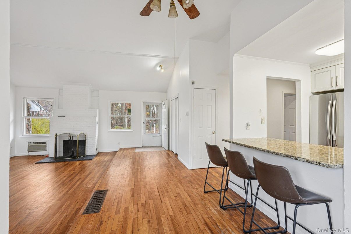 Empty room, Fireplace, Interior, Kitchen, Stainless Steel Appliances, Wood Texture Flooring