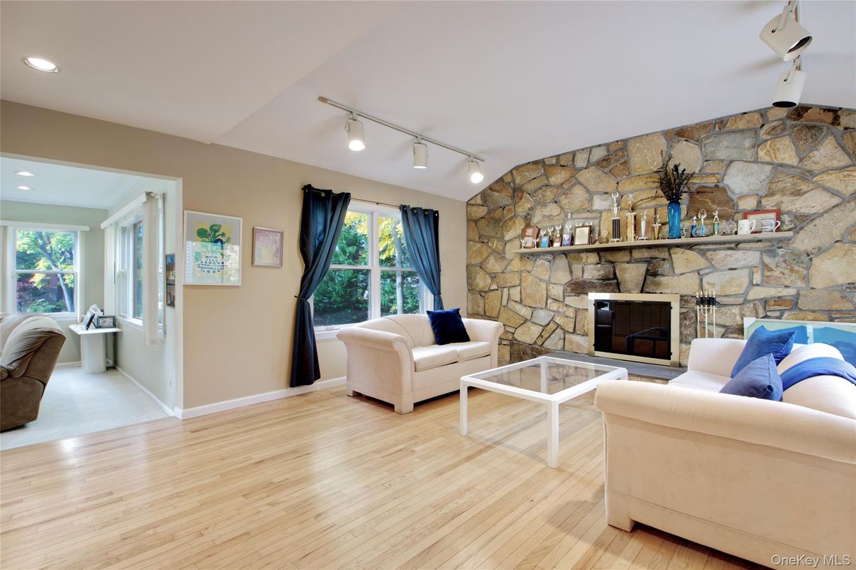 Fireplace, Interior, Living room, Recessed Lighting, Stone Walls, Wood Texture Flooring