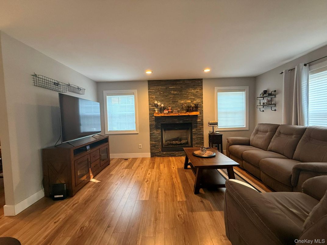 Fireplace, Interior, Living room, Recessed Lighting, Stone Walls, Wood Texture Flooring