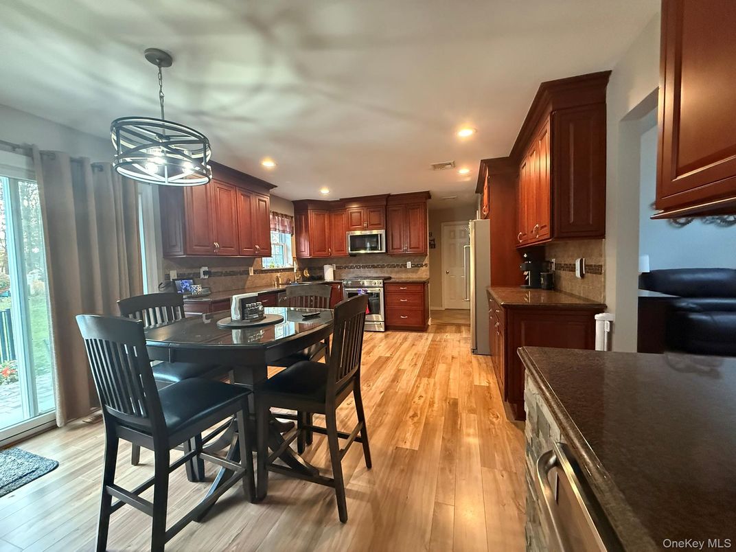 Dining room, Interior, Kitchen, Pendant Lights, Recessed Lighting, Stainless Steel Appliances, Wood Texture Flooring
