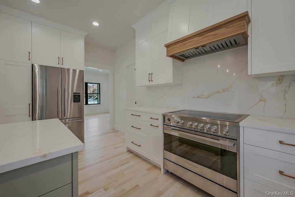 Interior, Kitchen, Marble Walls, Recessed Lighting, Stainless Steel Appliances, Wood Texture Flooring