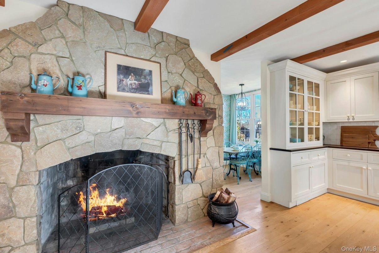 Chandelier, Dining room, Fireplace, Interior, Recessed Lighting, Stone Walls, Wooden Beams, Wood Texture Flooring