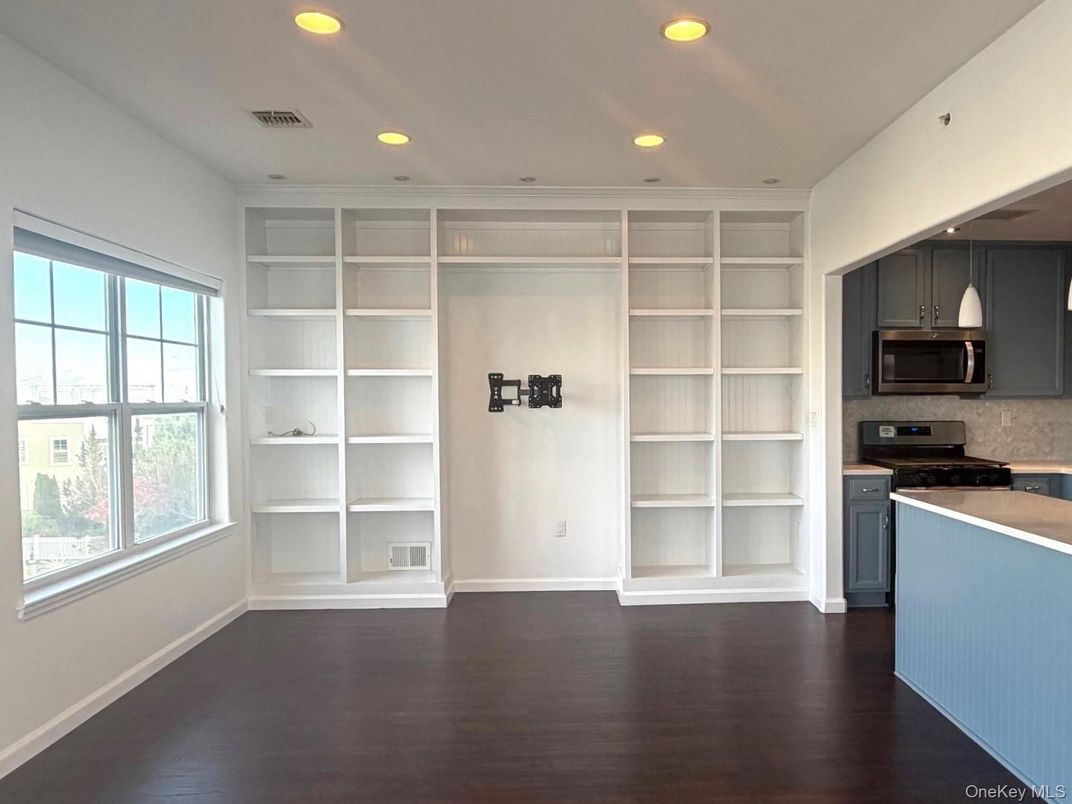 Empty room, Interior, Kitchen, Recessed Lighting, Stainless Steel Appliances, Wood Texture Flooring