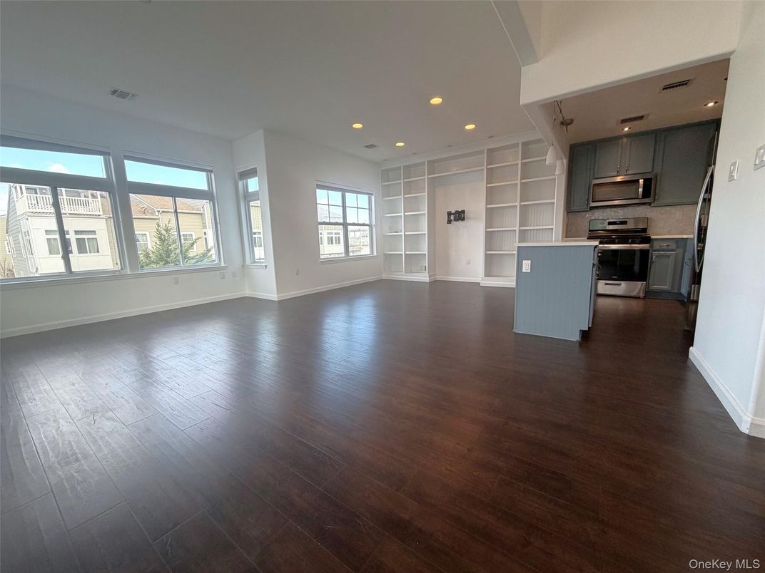 Empty room, Interior, Kitchen, Recessed Lighting, Stainless Steel Appliances, Wood Texture Flooring