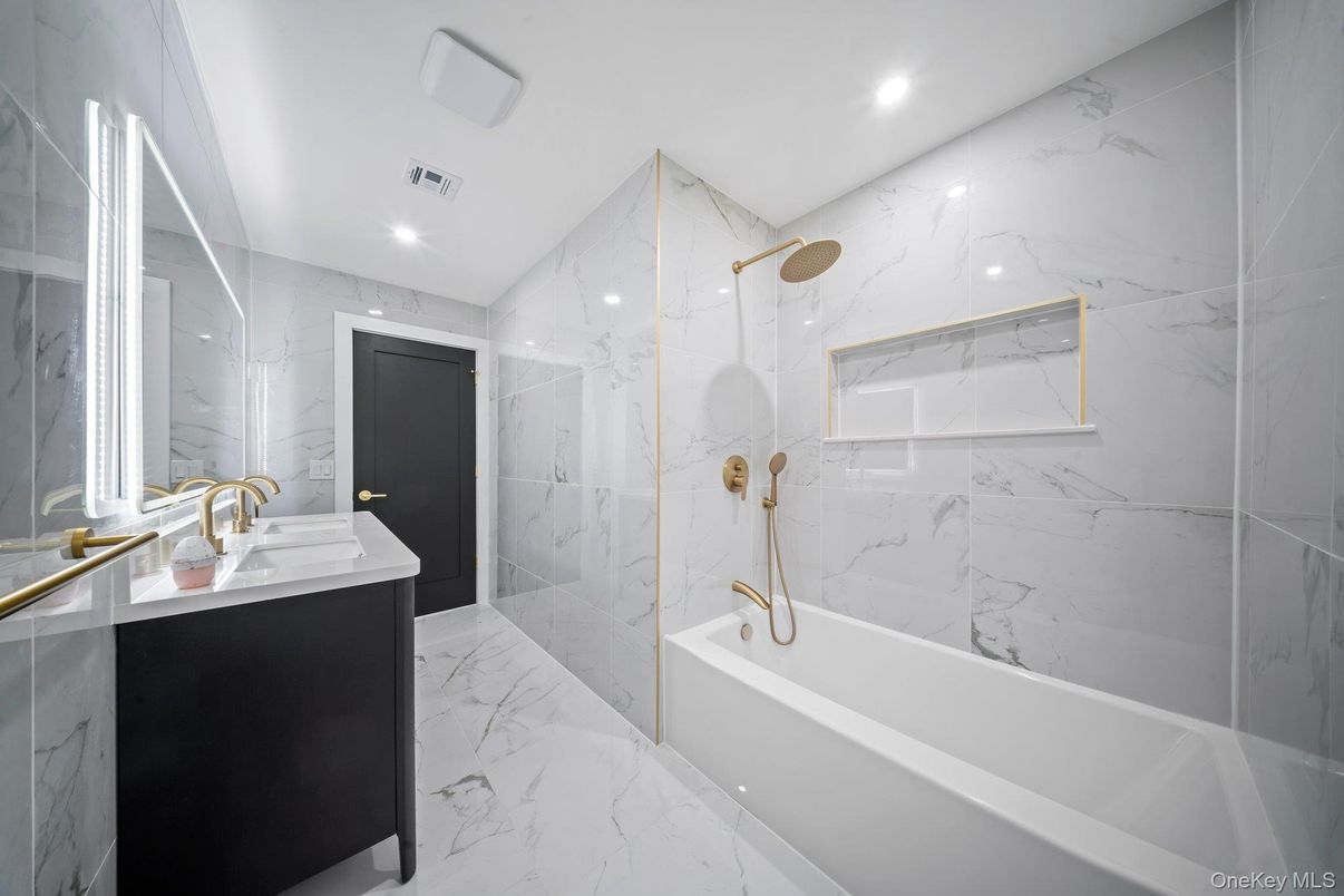 Bathroom, Dual Sink Vanities, Glass Shower, Interior, Marble, Marble Walls, Recessed Lighting