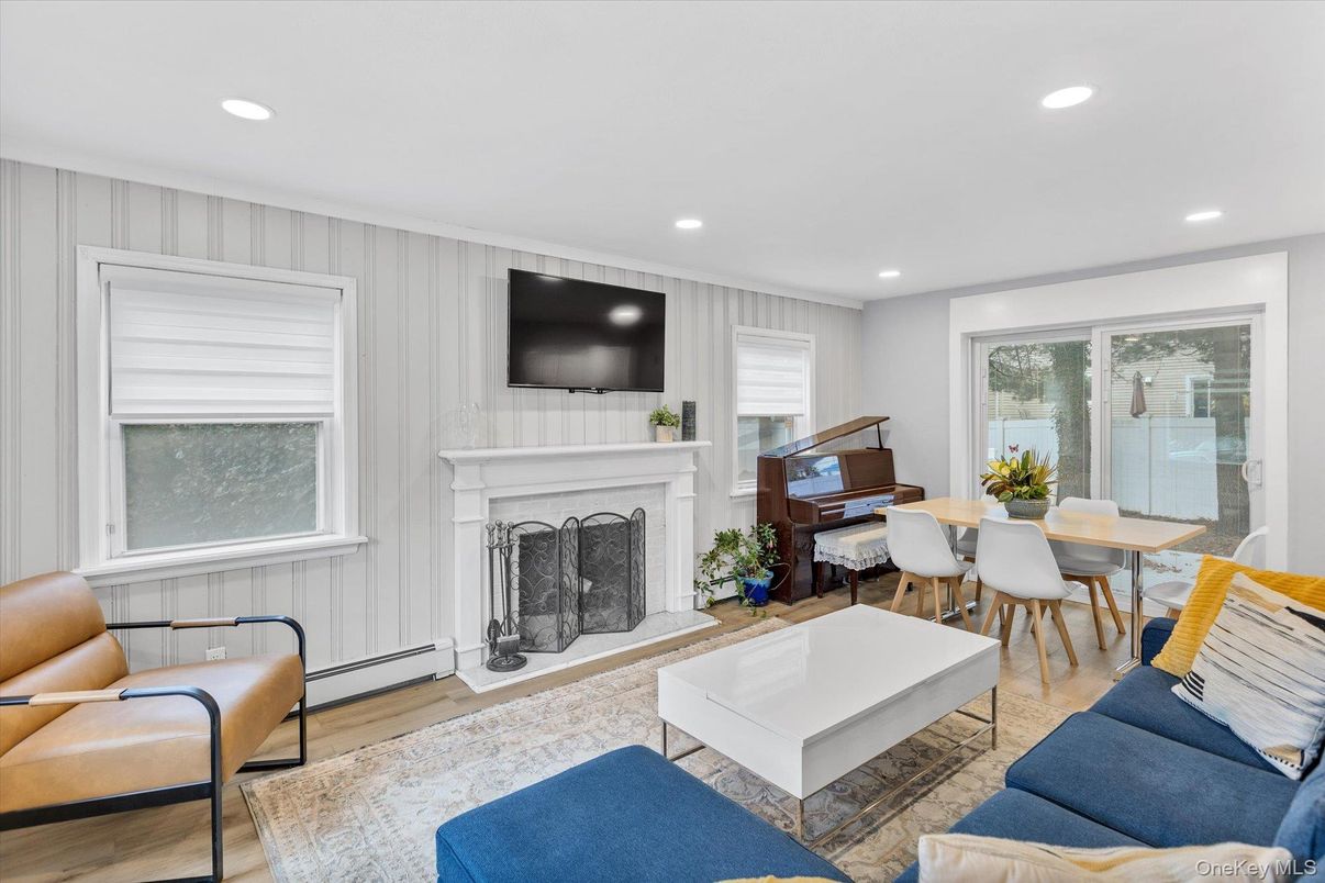 Dining room, Fireplace, Interior, Living room, Piano, Recessed Lighting, Wood Texture Flooring