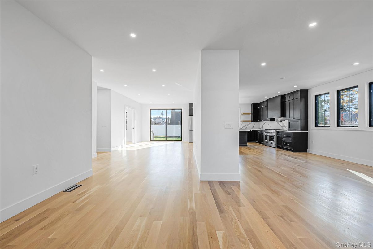 Empty room, Interior, Kitchen, Recessed Lighting, Stainless Steel Appliances, Wood Texture Flooring