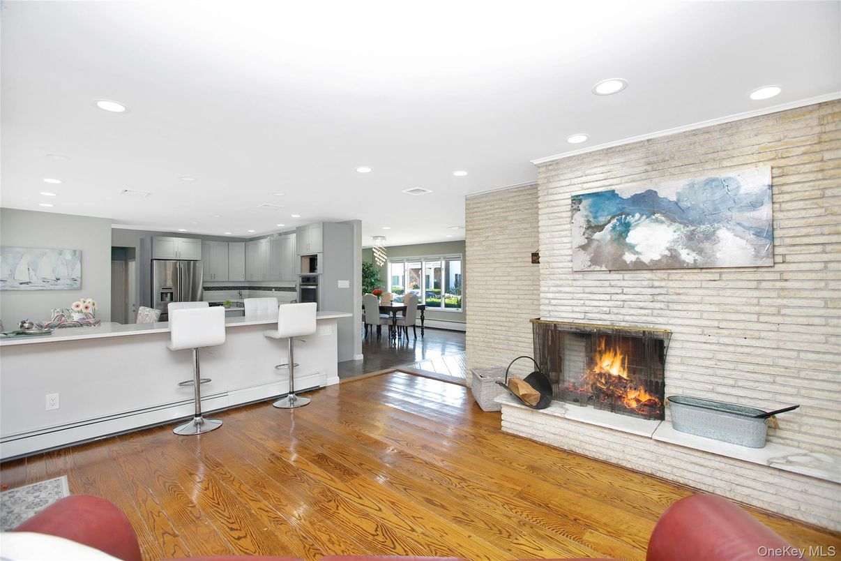 Dining room, Fireplace, Interior, Kitchen, Recessed Lighting, Stainless Steel Appliances, Stone Walls, Wood Texture Flooring