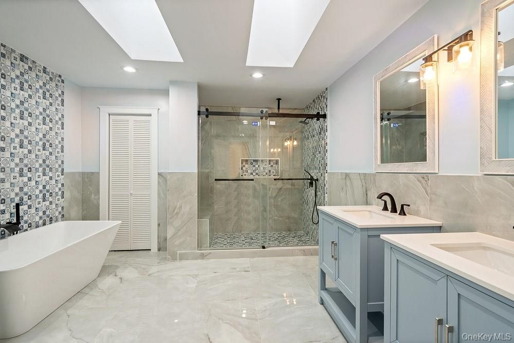 Bathroom, Dual Sink Vanities, Free Standing Baths, Glass Shower, Interior, Marble, Marble Walls, Recessed Lighting