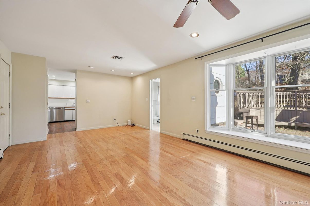 Empty room, Interior, Kitchen, Recessed Lighting, Stainless Steel Appliances, Wood Texture Flooring