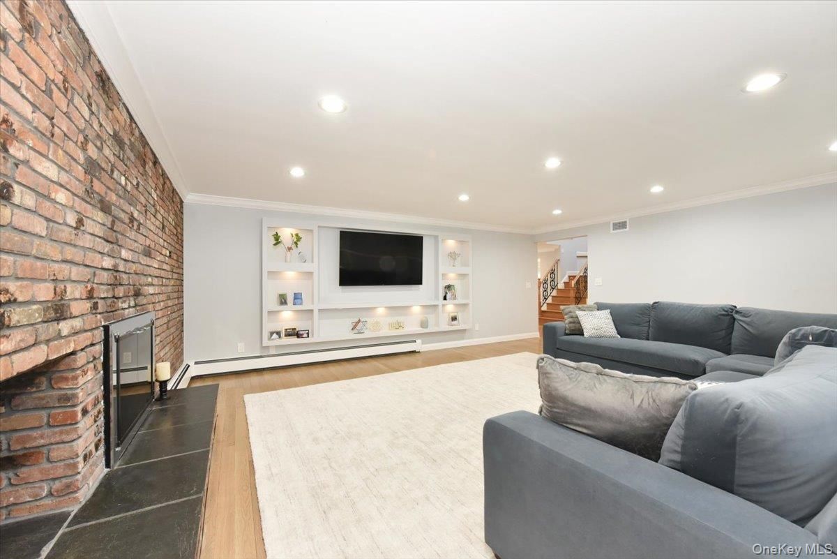 Fireplace, Interior, Living room, Recessed Lighting, Stone Walls, Wood Texture Flooring