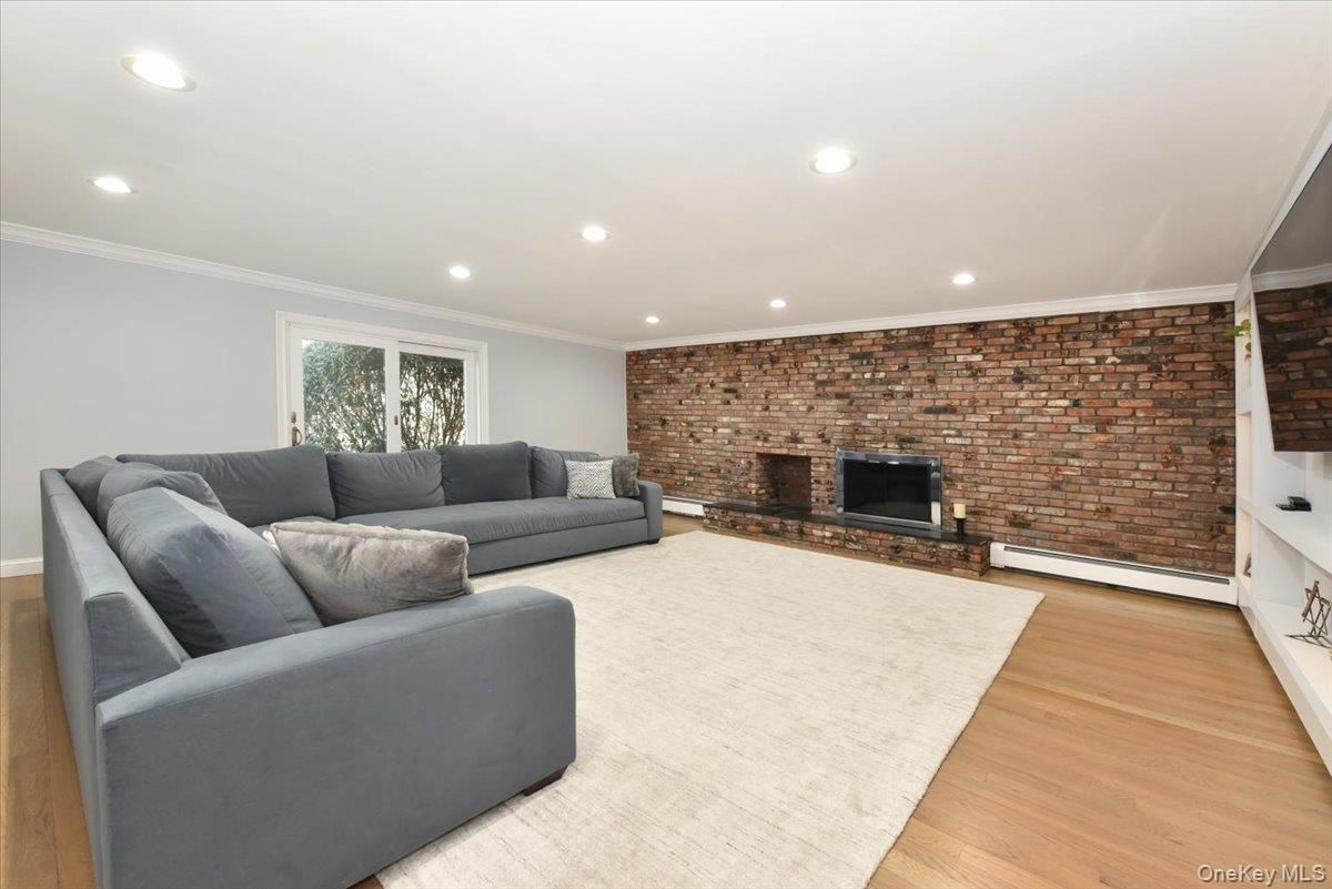 Fireplace, Interior, Living room, Recessed Lighting, Stone Walls, Wood Texture Flooring