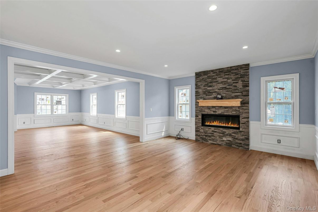 Empty room, Fireplace, Interior, Recessed Lighting, Stone Walls, Wood Texture Flooring
