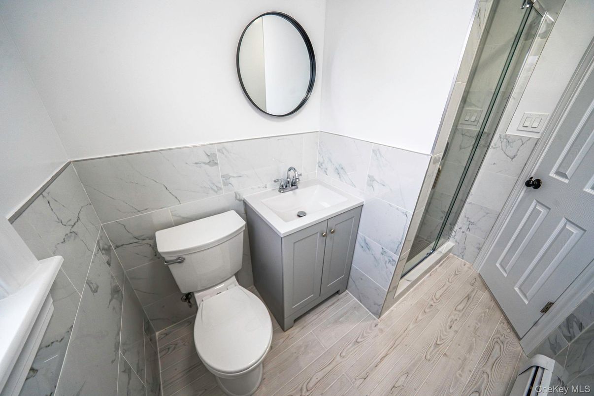 Bathroom, Glass Shower, Interior, Marble Walls, Wood Texture Flooring