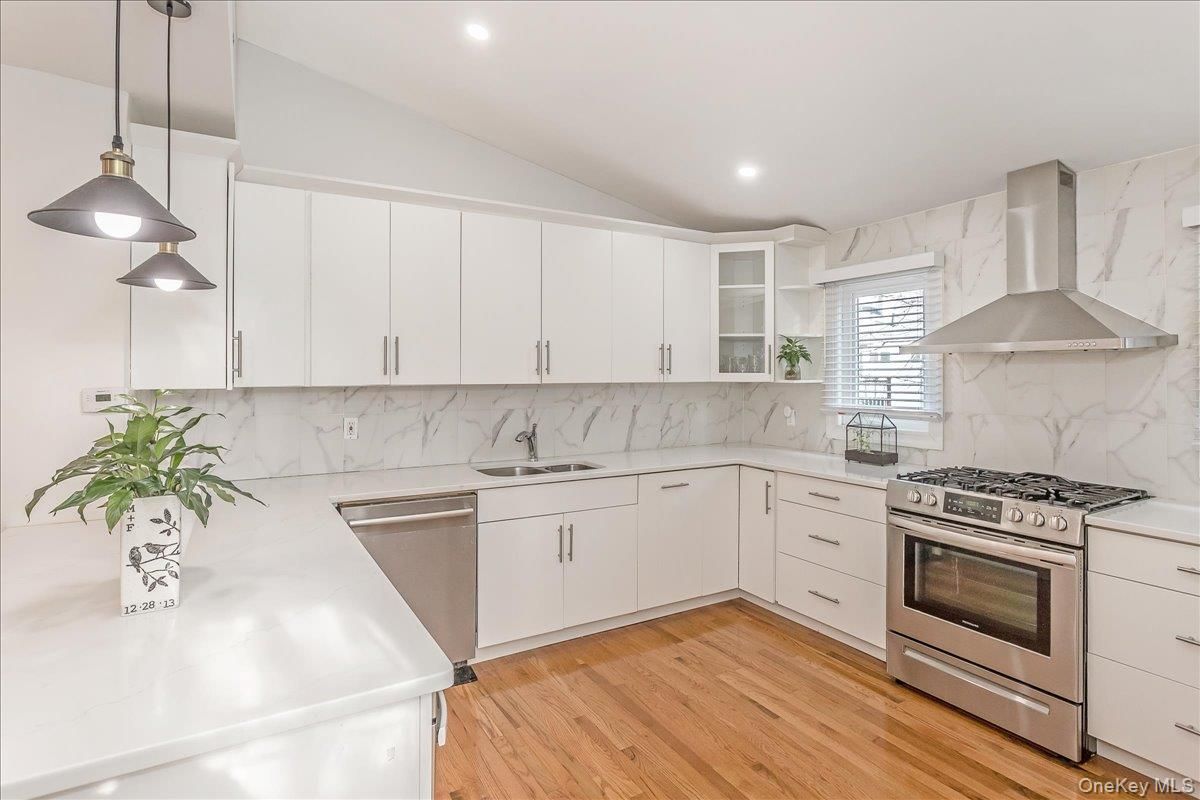 Interior, Kitchen, Marble Walls, Pendant Lights, Recessed Lighting, Stainless Steel Appliances, Wood Texture Flooring