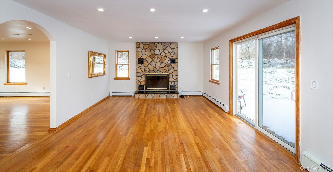 Empty room, Fireplace, Interior, Recessed Lighting, Stone Walls, Wood Texture Flooring