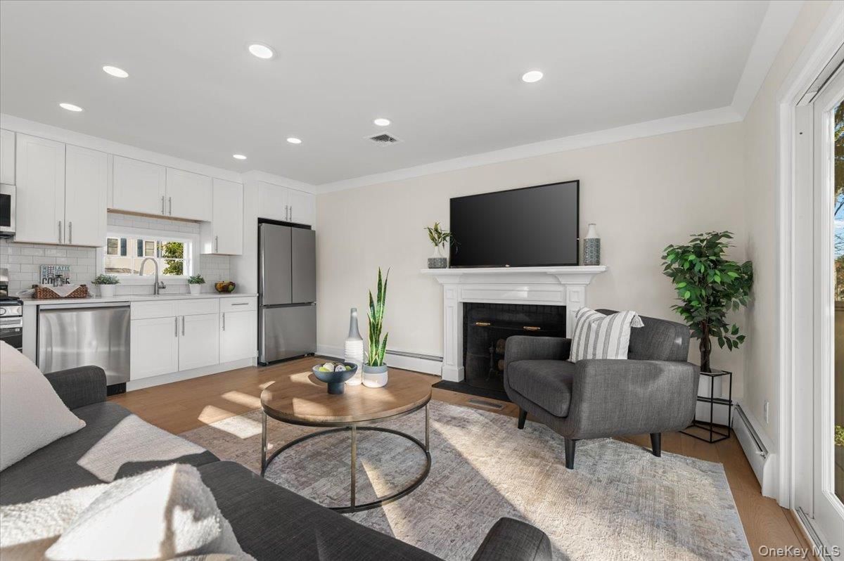 Fireplace, Interior, Kitchen, Living room, Recessed Lighting, Stainless Steel Appliances, Wood Texture Flooring