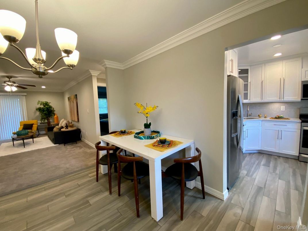 Chandelier, Dining room, Interior, Kitchen, Recessed Lighting, Stainless Steel Appliances, Wood Texture Flooring