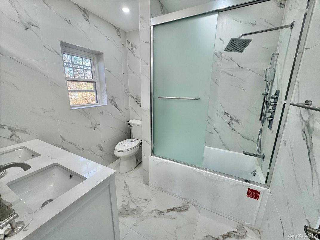 Bathroom, Dual Sink Vanities, Glass Shower, Interior, Marble, Marble Walls, Recessed Lighting