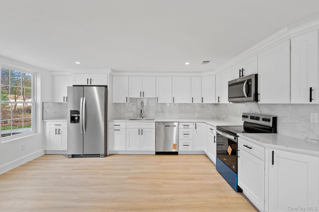 Interior, Kitchen, Marble Walls, Recessed Lighting, Stainless Steel Appliances, Wood Texture Flooring