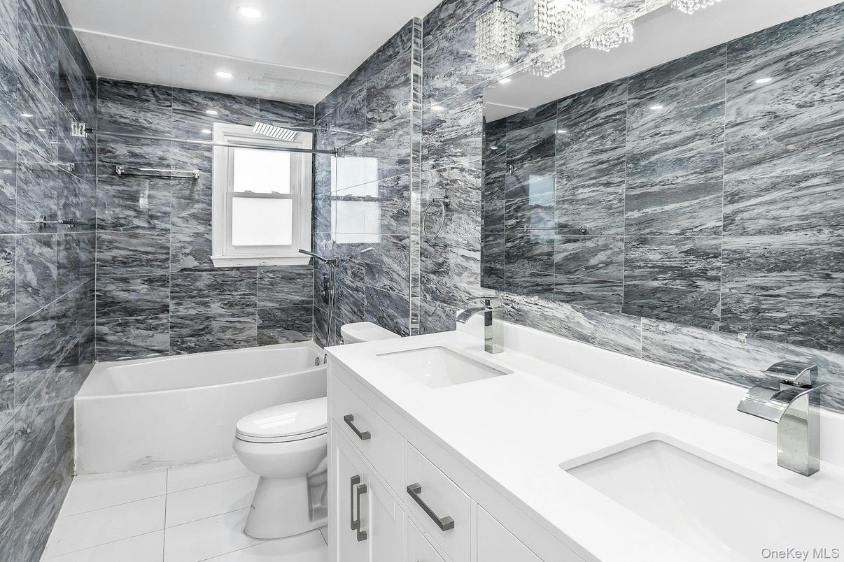 Bathroom, Dual Sink Vanities, Glass Shower, Interior, Marble, Marble Walls, Recessed Lighting