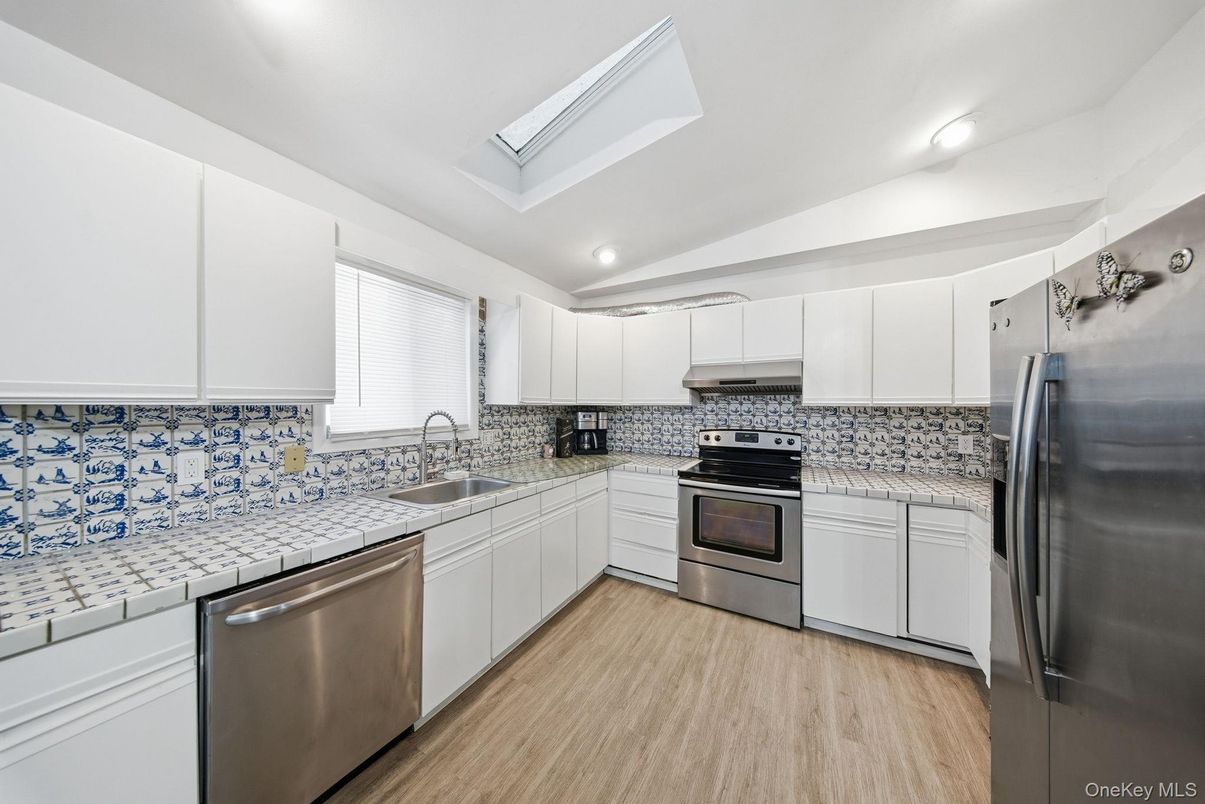 Interior, Kitchen, Recessed Lighting, Stainless Steel Appliances, Tile Countertops, Wood Texture Flooring