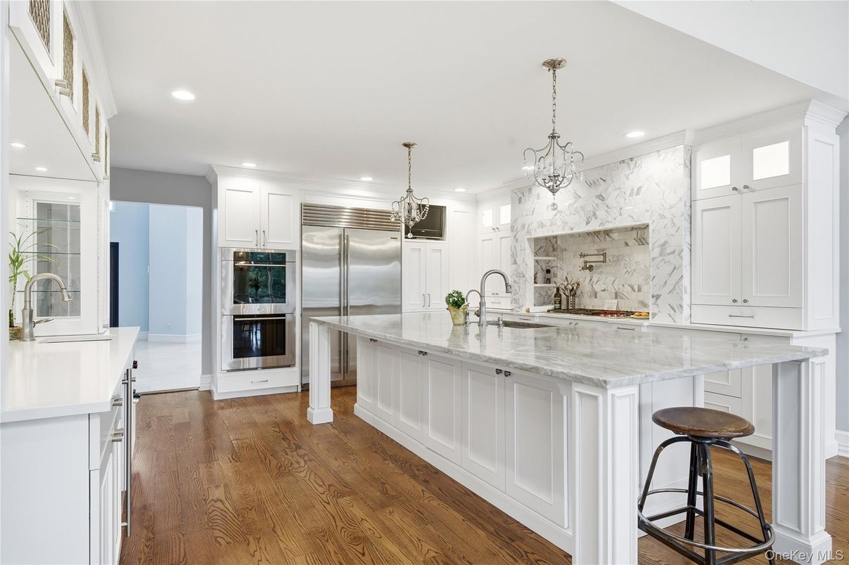 Chandelier, Interior, Kitchen, Marble Walls, Pendant Lights, Recessed Lighting, Stainless Steel Appliances, Wood Texture Flooring