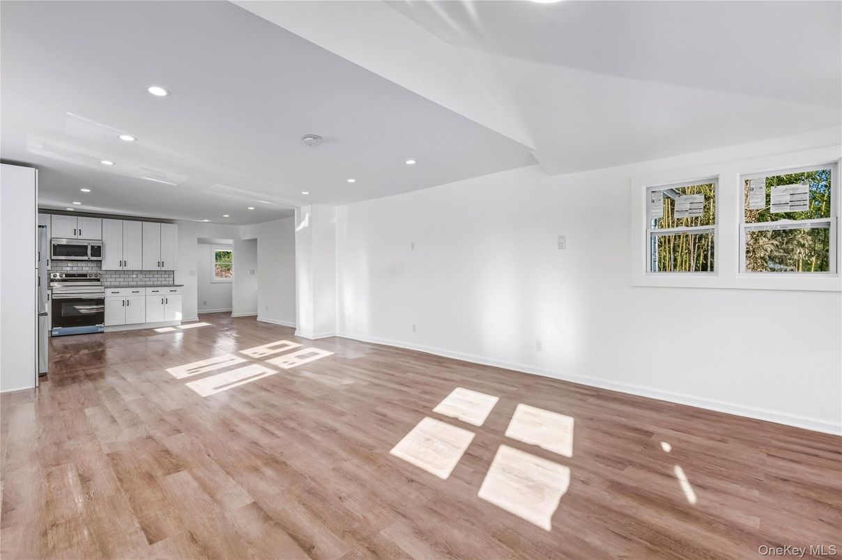 Empty room, Interior, Kitchen, Recessed Lighting, Stainless Steel Appliances, Wood Texture Flooring