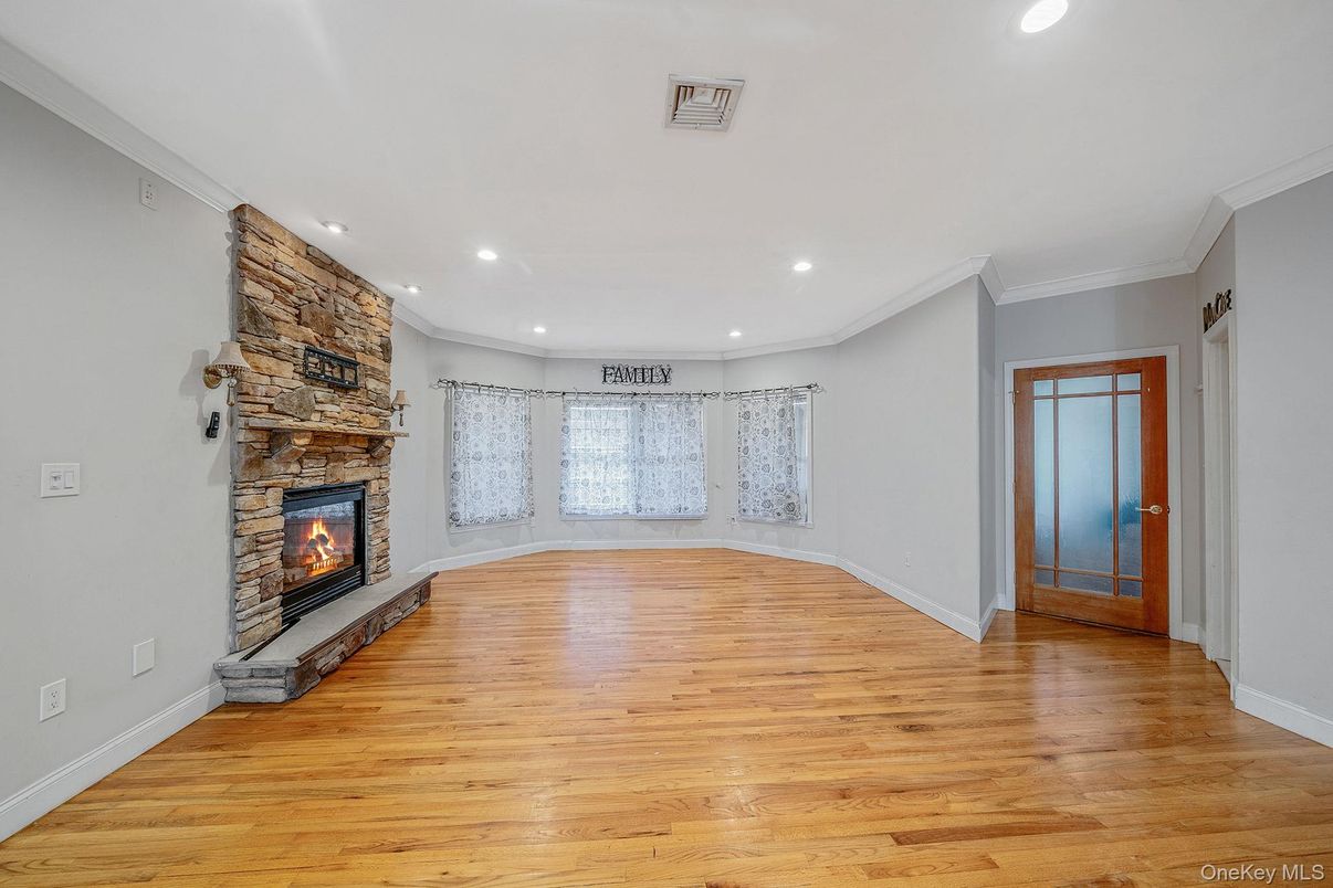 Empty room, Fireplace, Interior, Recessed Lighting, Stone Walls, Wood Texture Flooring