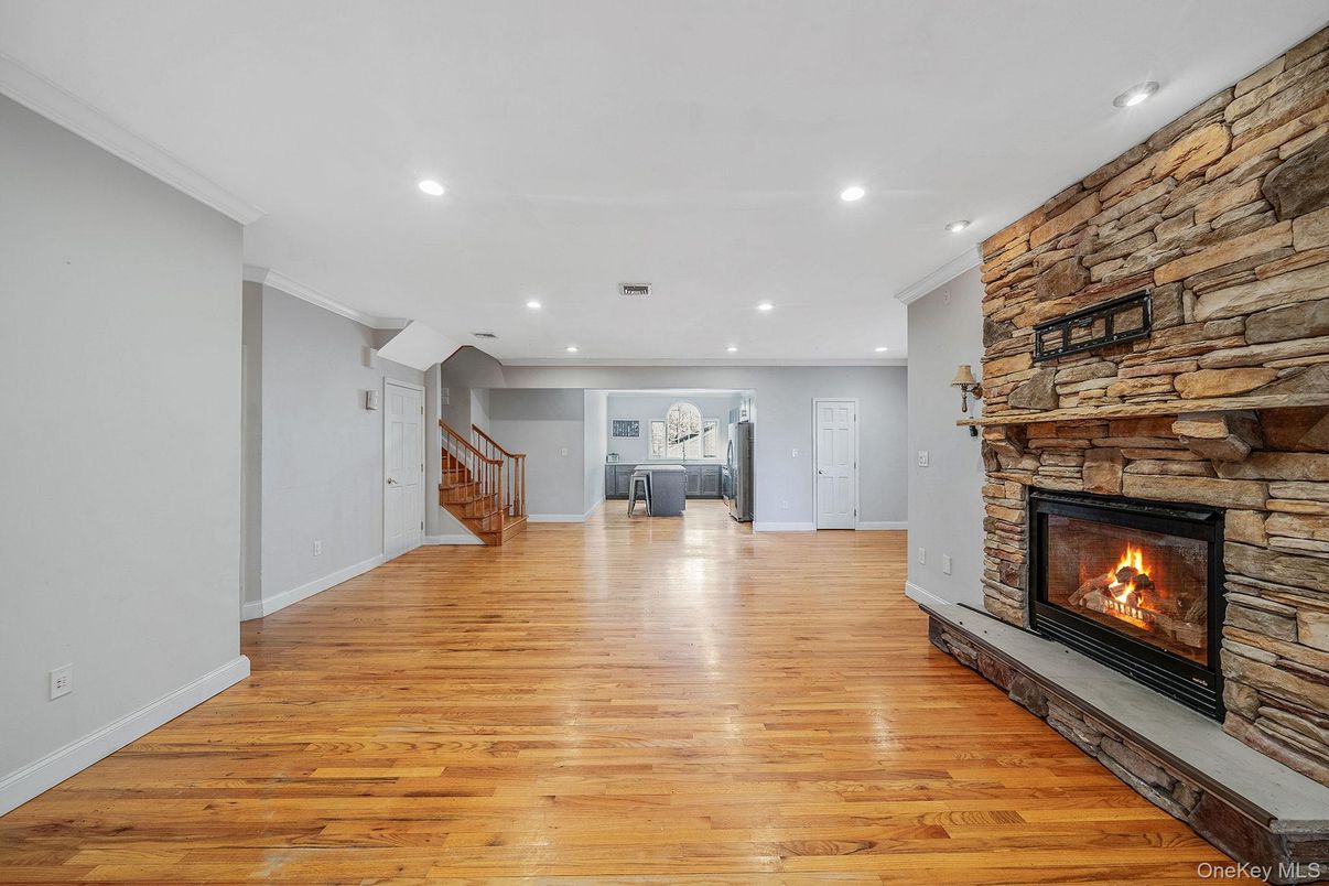 Empty room, Fireplace, Interior, Recessed Lighting, Stone Walls, Wood Texture Flooring