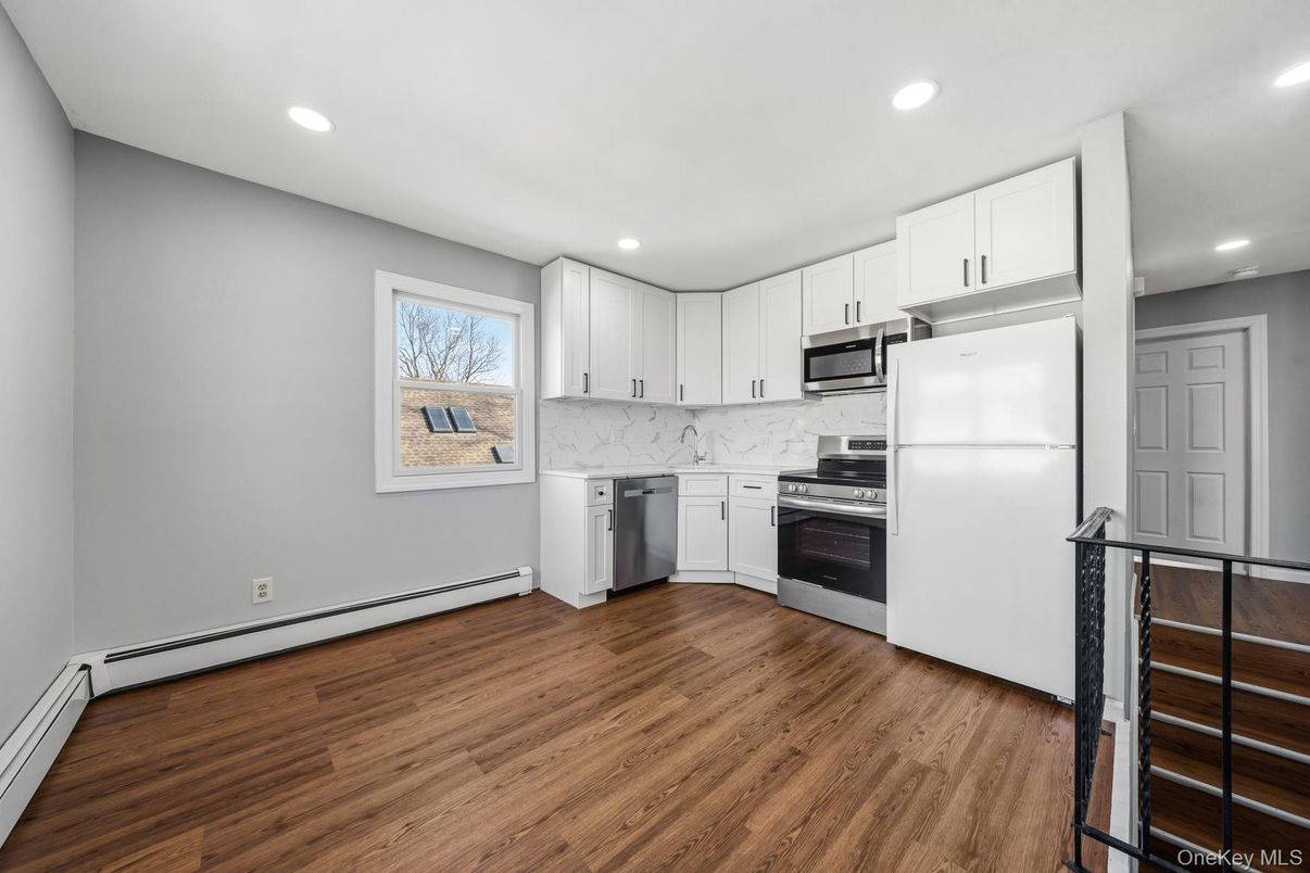 Interior, Kitchen, Marble Walls, Recessed Lighting, Stainless Steel Appliances, Wood Texture Flooring