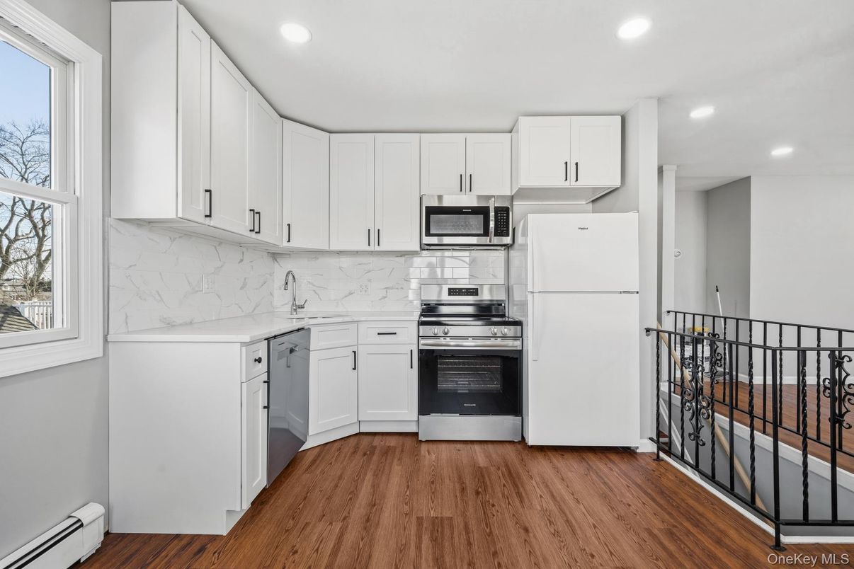 Interior, Kitchen, Marble Walls, Recessed Lighting, Stainless Steel Appliances, Wood Texture Flooring