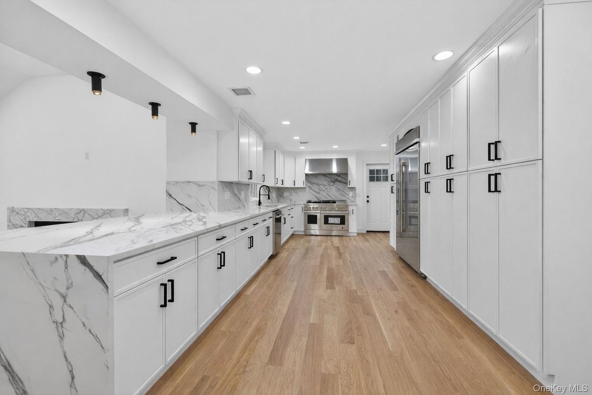 Interior, Kitchen, Marble Walls, Recessed Lighting, Stainless Steel Appliances, Wood Texture Flooring