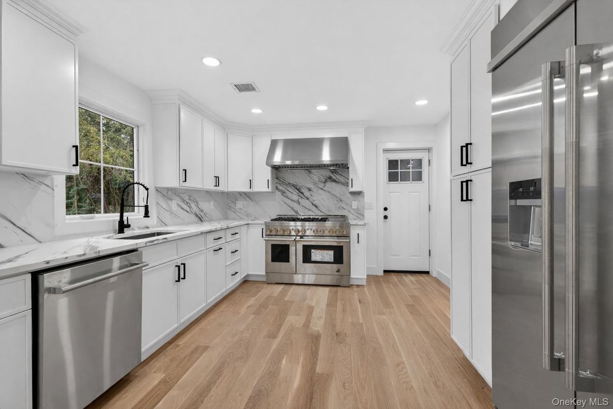 Interior, Kitchen, Marble Walls, Recessed Lighting, Stainless Steel Appliances, Wood Texture Flooring