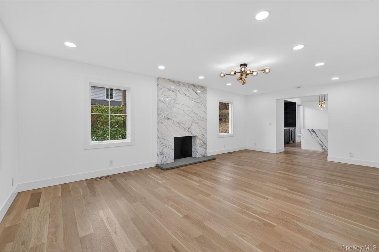 Empty room, Fireplace, Interior, Marble Walls, Recessed Lighting, Wood Texture Flooring