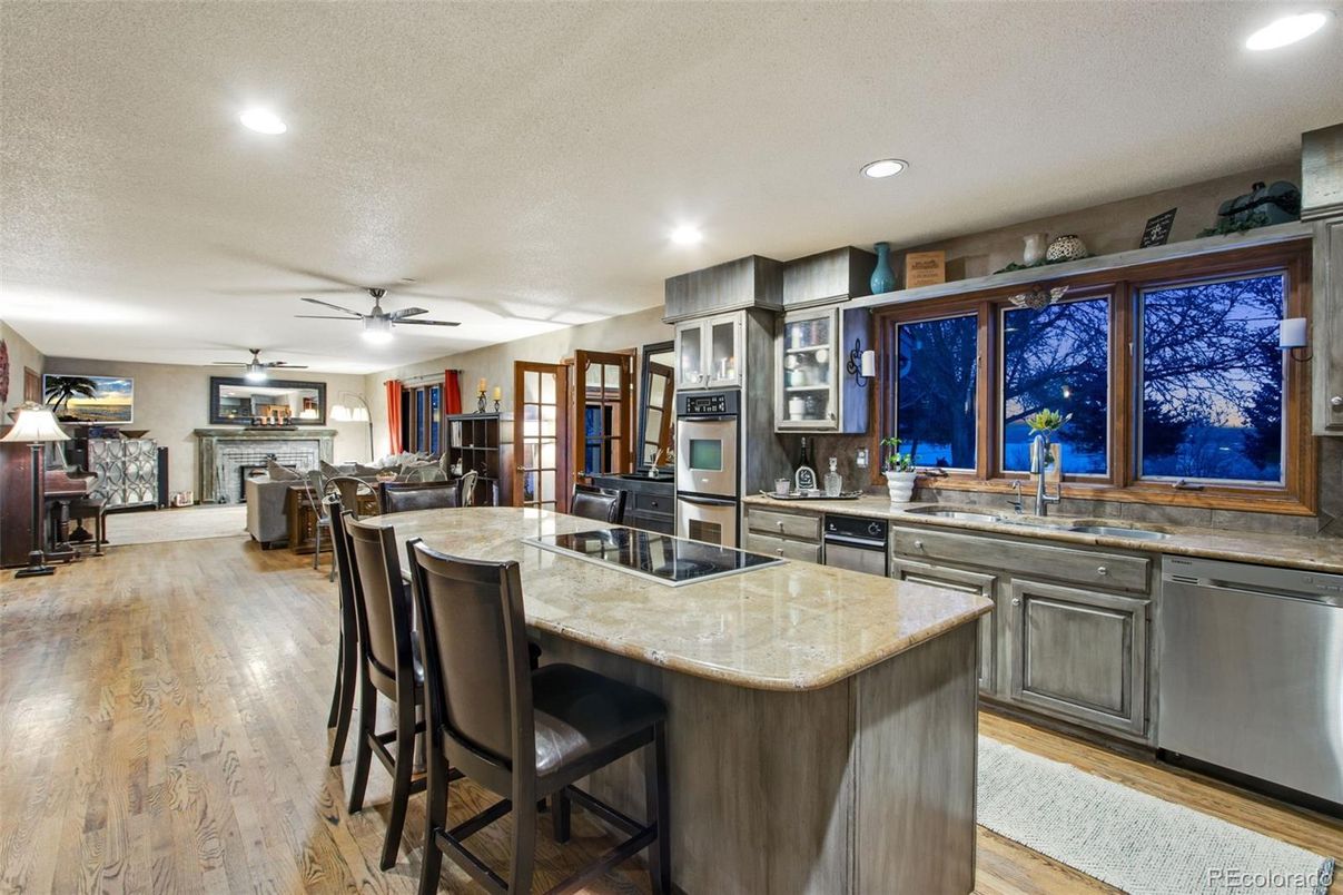 Dining room, Fireplace, Interior, Kitchen, Recessed Lighting, Stainless Steel Appliances, Wood Texture Flooring
