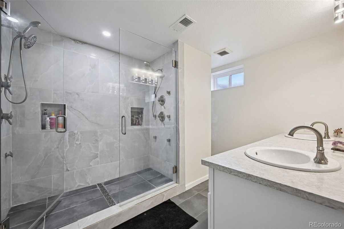 Bathroom, Dual Sink Vanities, Glass Shower, Interior, Marble Walls, Recessed Lighting