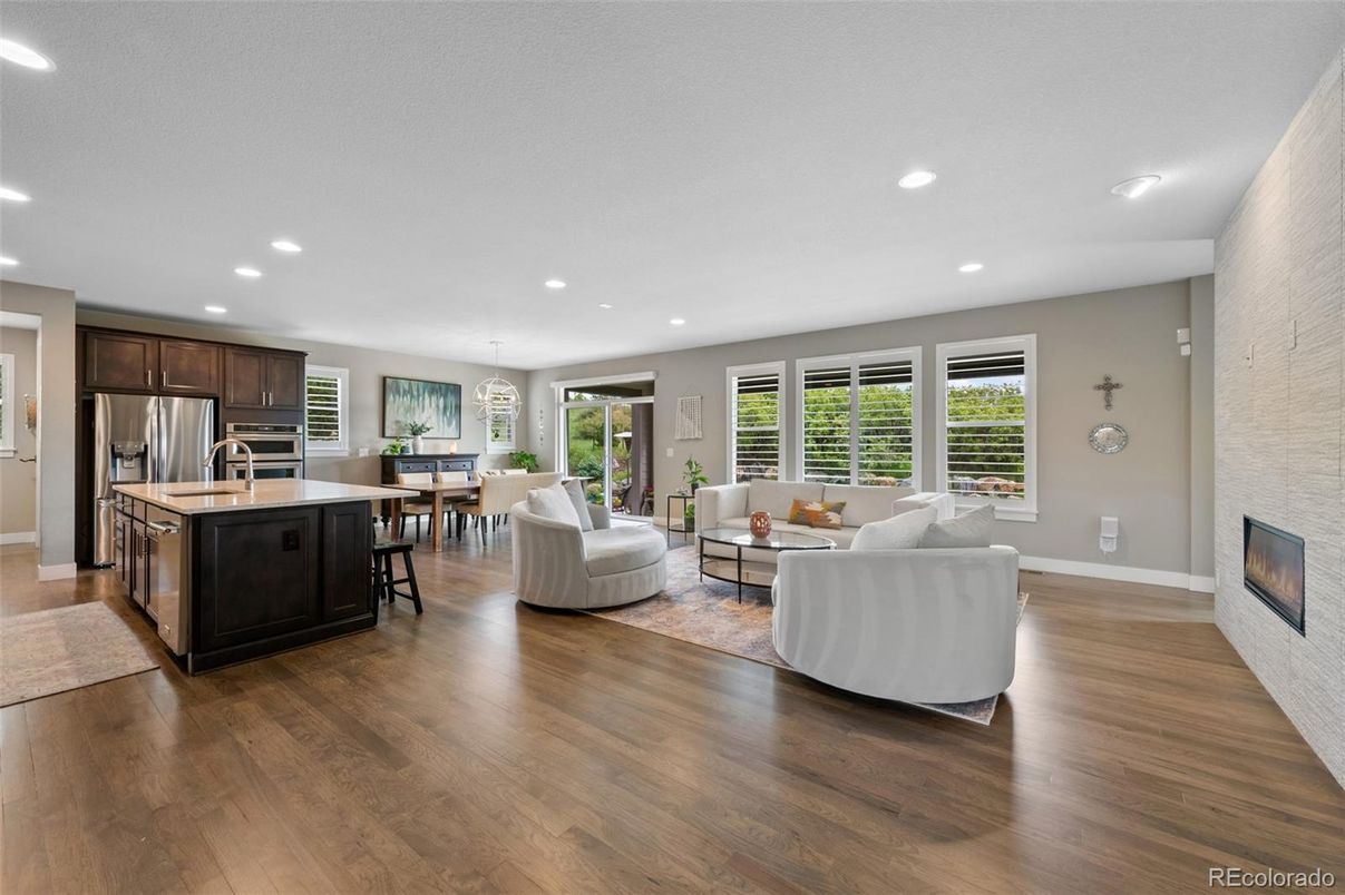 Dining room, Fireplace, Interior, Kitchen, Living room, Recessed Lighting, Stainless Steel Appliances, Wood Texture Flooring