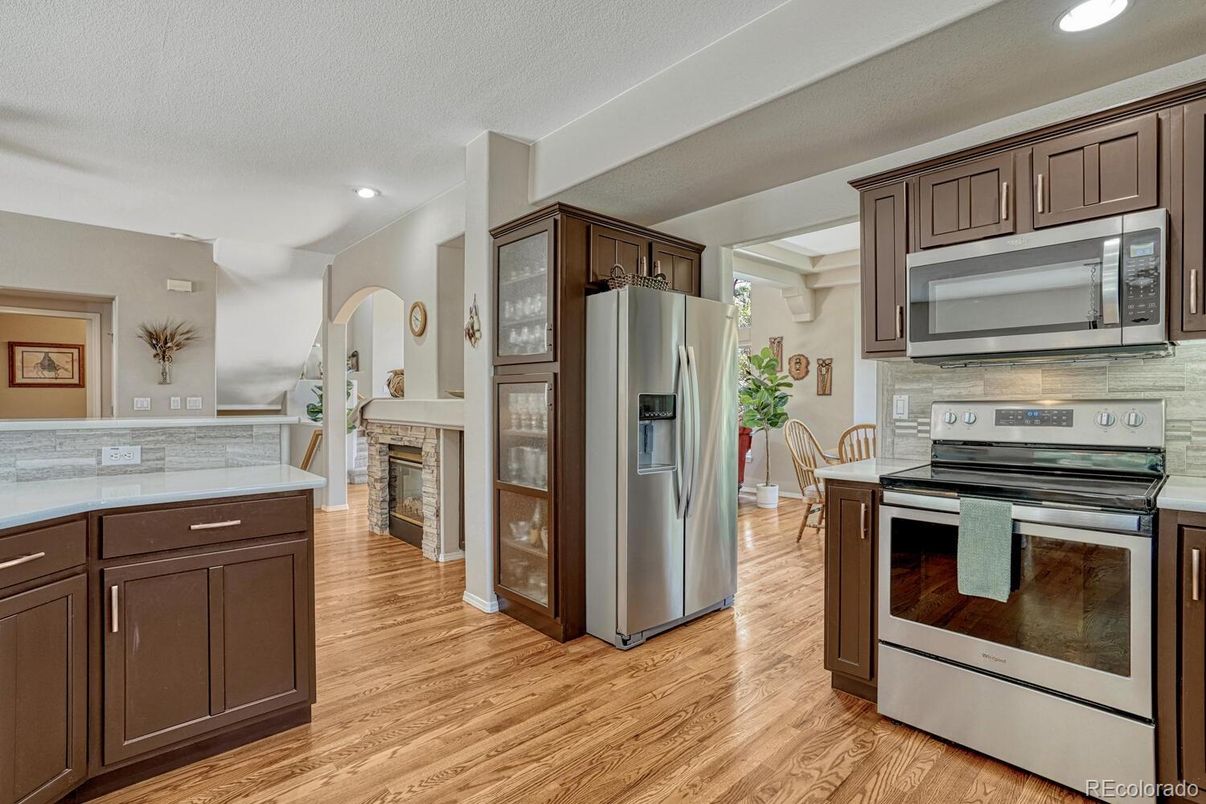 Fireplace, Interior, Kitchen, Recessed Lighting, Stainless Steel Appliances, Wood Texture Flooring