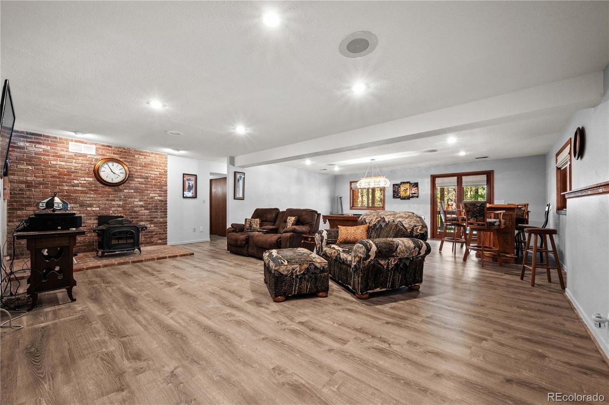 Chandelier, Dining room, Fireplace, Interior, Living room, Pendant Lights, Recessed Lighting, Stone Walls, Wood Texture Flooring